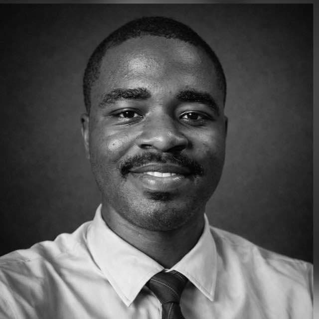 Osunyemi Promise Oluwaseyi, in a light shirt and tie, photographed against a dark studio background.